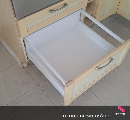 מגירת עץ נשלפת עם מסילות איכותיות מותקנת ביחידת ארון